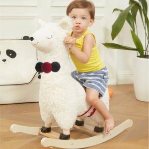 Toddler is riding the Rocking horse Llama toy